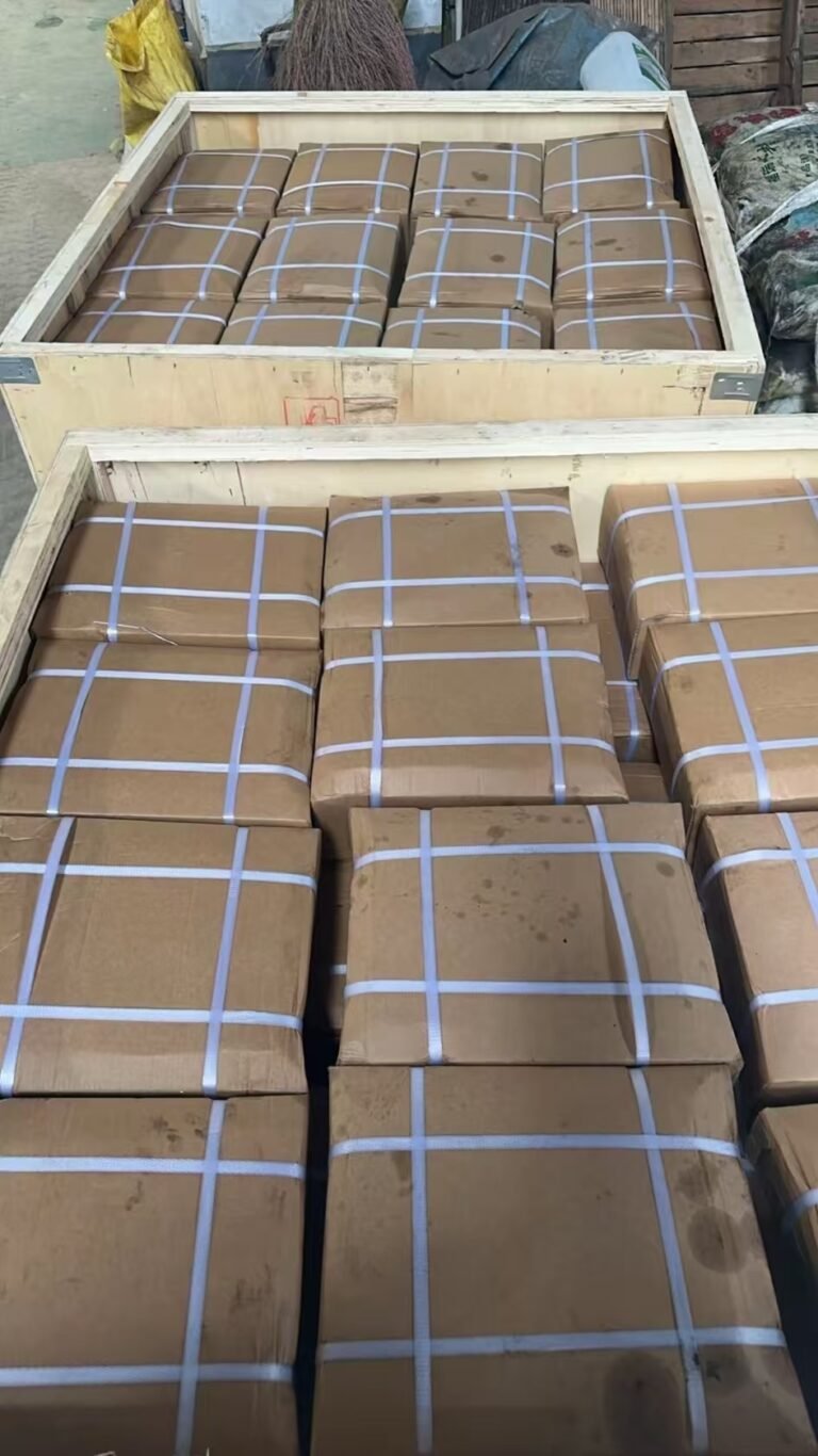 Strapped cartons packed inside wooden cases for export shipment