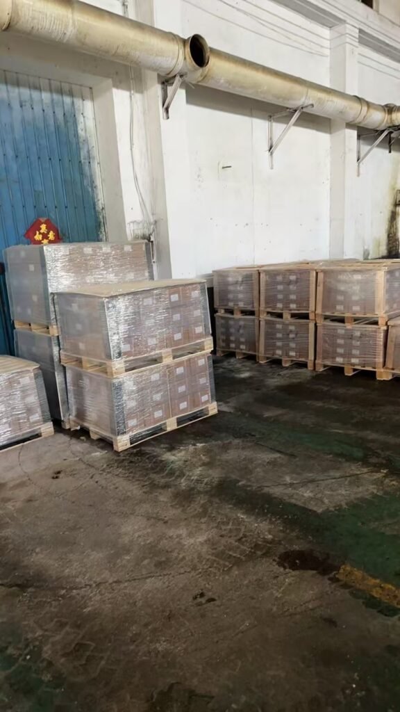 Wrapped pallets of fastener cartons staged in the packing area